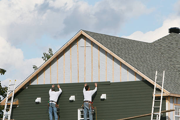 Professional Storm Damage Siding Repair technician working in West Liberty, OH